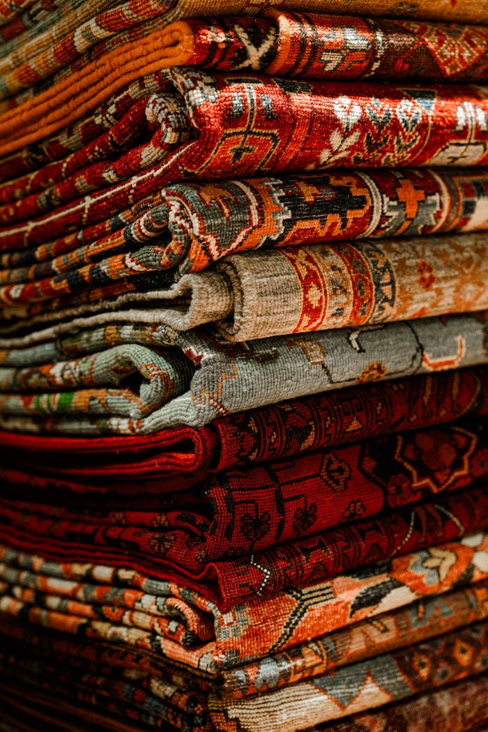 about-img A colorful assortment of Persian rugs showcasing intricate designs and rich textures, perfect for interior decor.