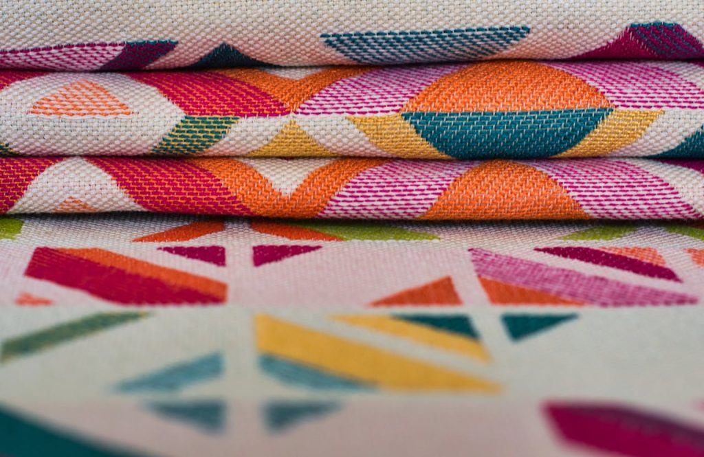 Brightly colored textiles with geometric patterns, ideal for creative projects or vibrant decor.